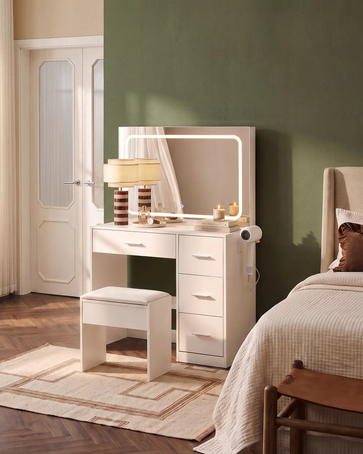 Luna white dressing table set with illuminated mirror and matching stool, styled beside a bed in a contemporary neutral bedroom.
