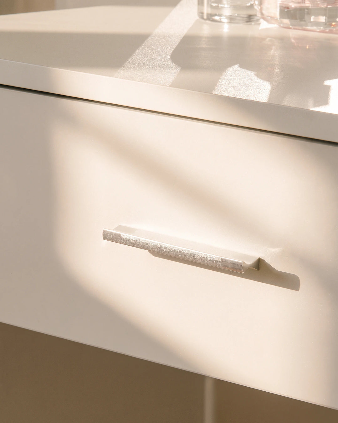 Close-up of the Luna dressing table drawer with a sleek handle and smooth white finish.