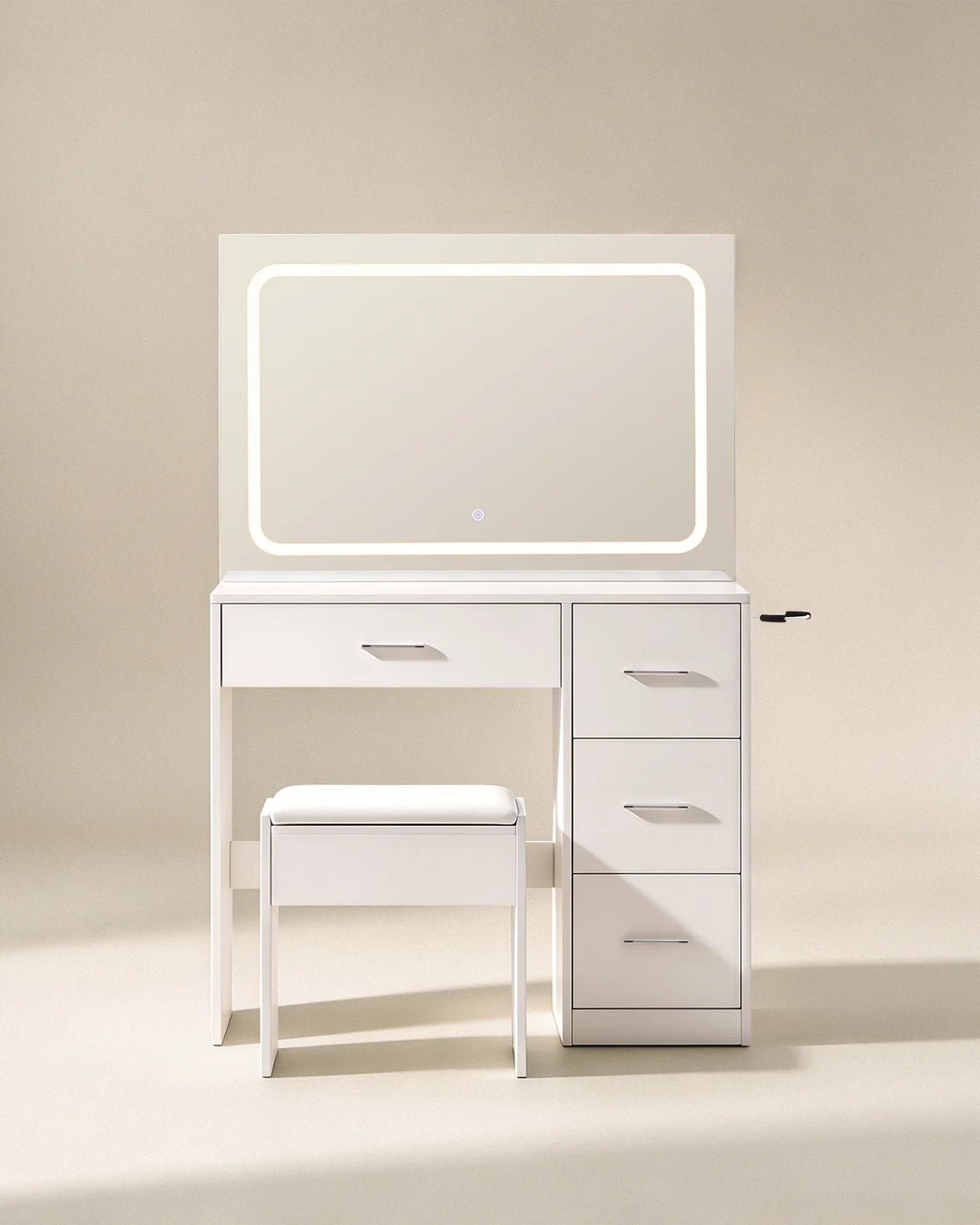 Front view of the Luna white dressing table set with illuminated rectangular mirror, compact drawer storage and matching stool against a neutral background.
