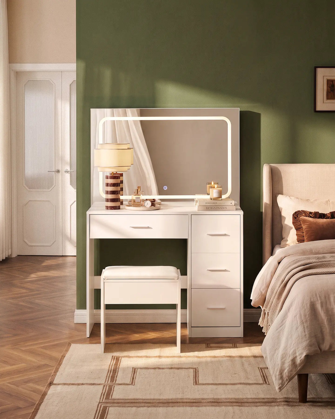 Luna white dressing table set with matching stool and illuminated rectangular mirror, styled in a warm neutral bedroom with a green accent wall.