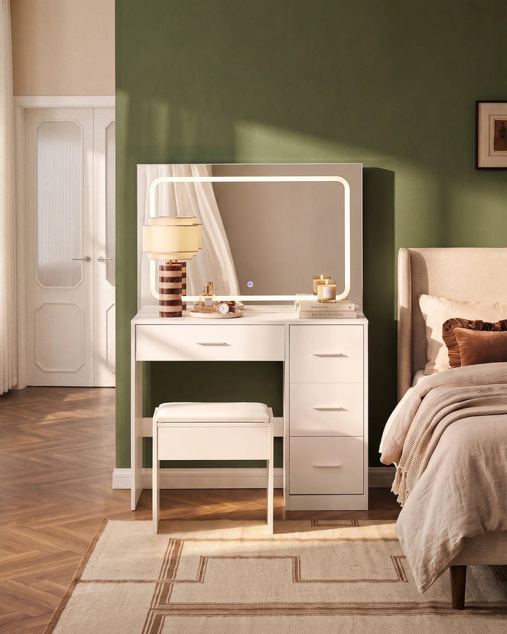 Luna white dressing table set with matching stool and illuminated rectangular mirror, styled in a warm neutral bedroom with a green accent wall.