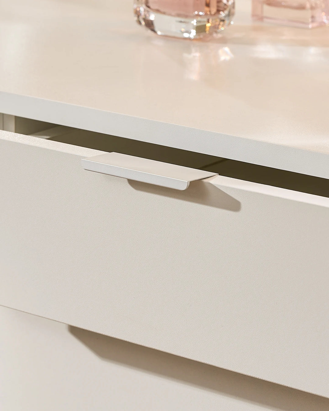 Detail of the Lunea white dressing table drawer with a slim integrated handle and clean, modern drawer-front finish.