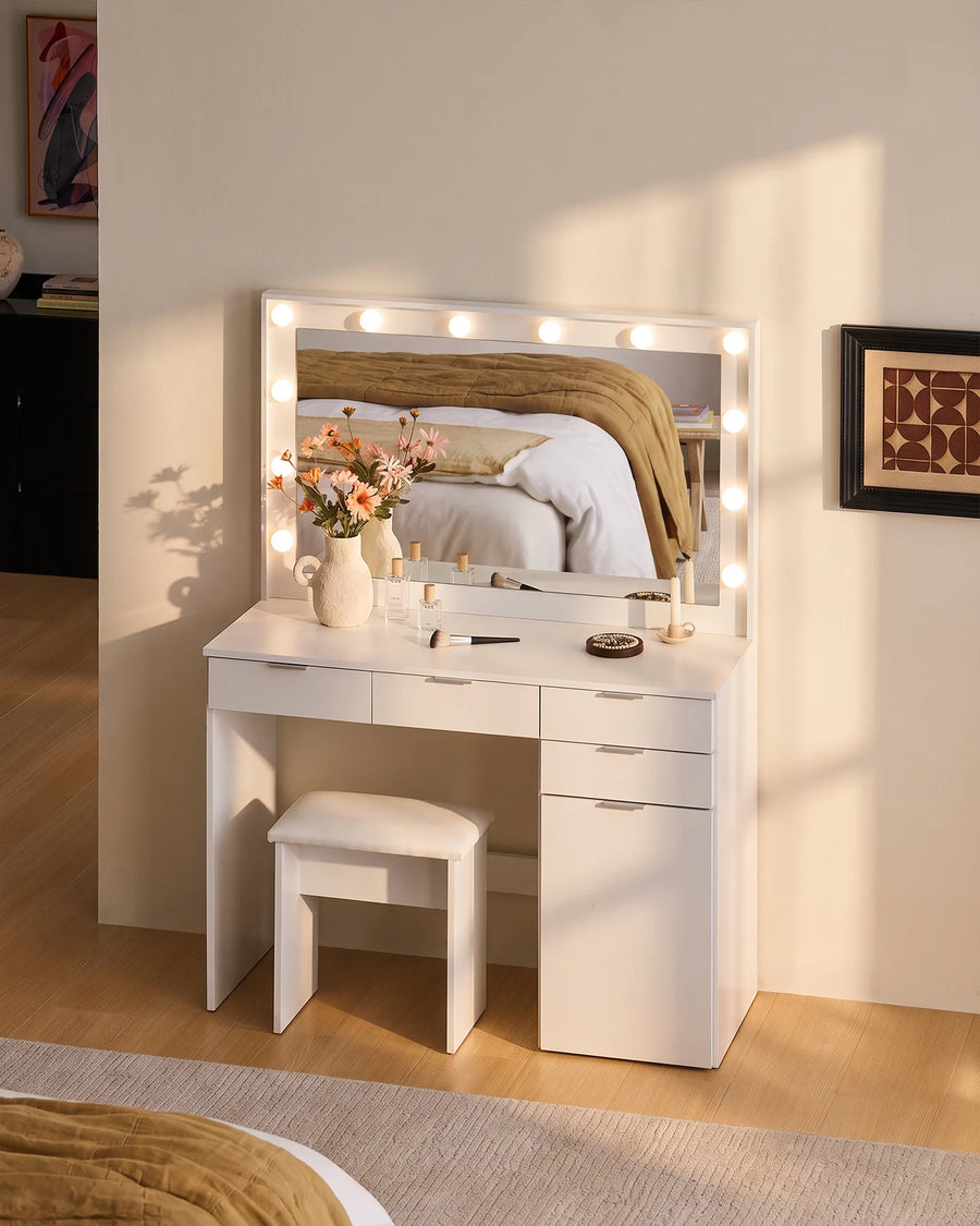 White Lunea dressing table set with LED mirror, matching stool and decorative accessories, styled in a bright bedroom with a soft neutral palette.