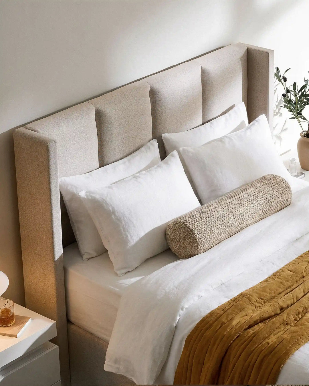 Close-up of the Luvon beige upholstered headboard with padded backrest