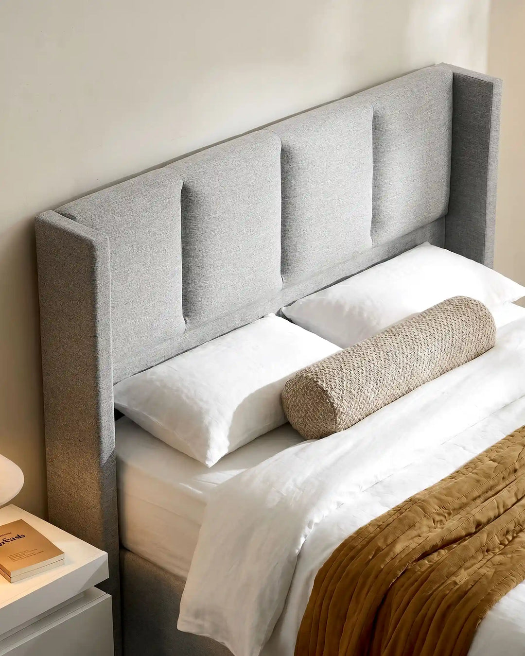 Close-up of the Luvon grey upholstered headboard with padded backrest
