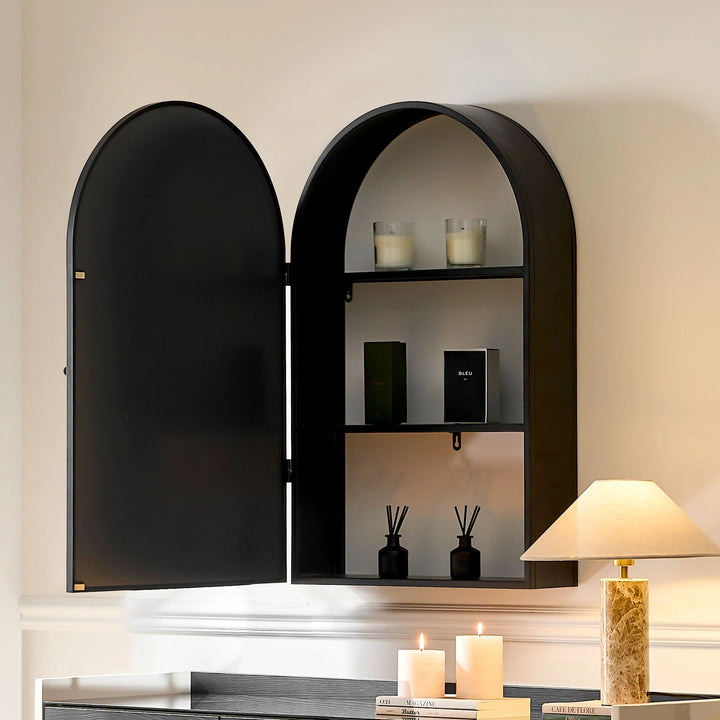 Side view of Margot arched Mirror as hallway mirror with cabinet doors open, showing candles and décor items on three shelves