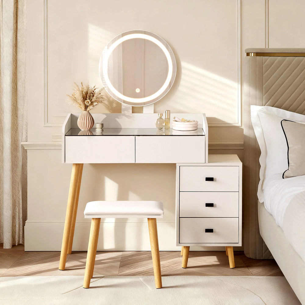 Marilee dressing table with round LED mirror lights switched on beside the bed