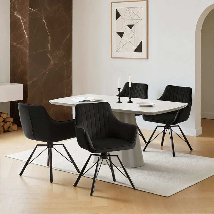 Set of four black Milo velvet dining chairs around a dining table