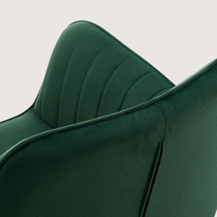 Close-up of Milo swivel chair showing soft velvet fabric and detailed stitching on armrests
