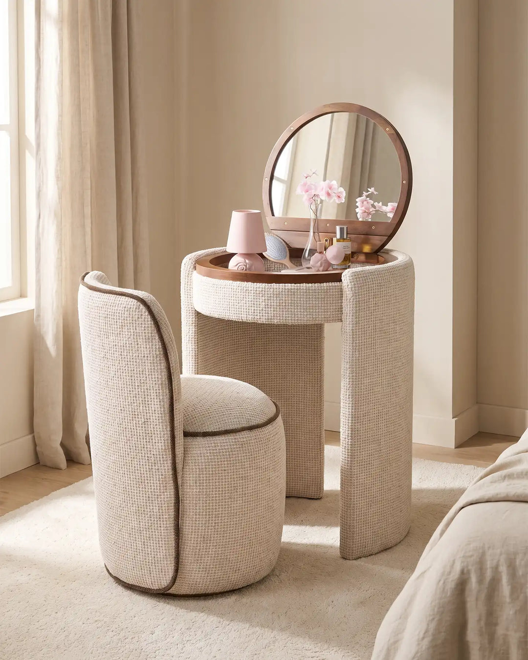 Mina cream chenille upholstered dressing table set styled in a bright bedroom, with a round mirror and matching stool