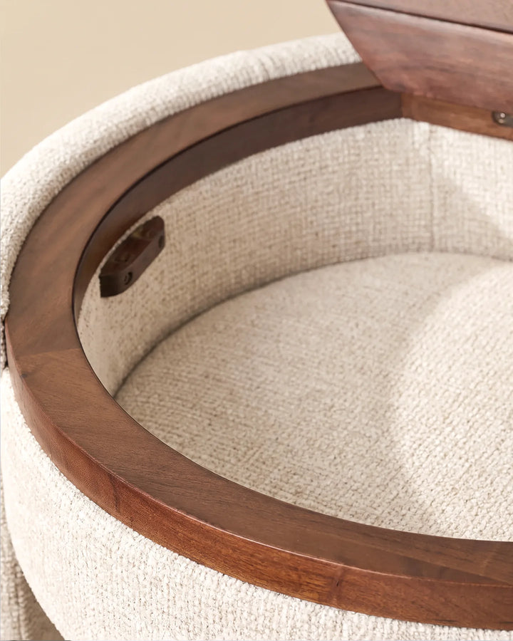 Close-up of the Mina dressing table's round mirror, cream chenille upholstery and warm wooden trim around the tabletop