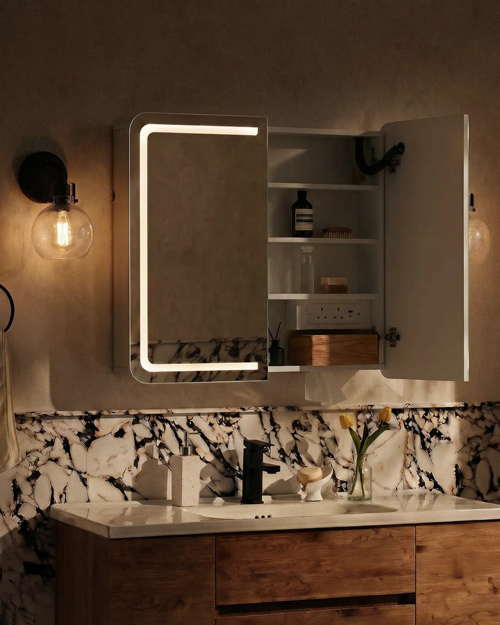 Mira anti fog bathroom mirror cabinet at night with LED lighting, half-open door showing storage shelves
