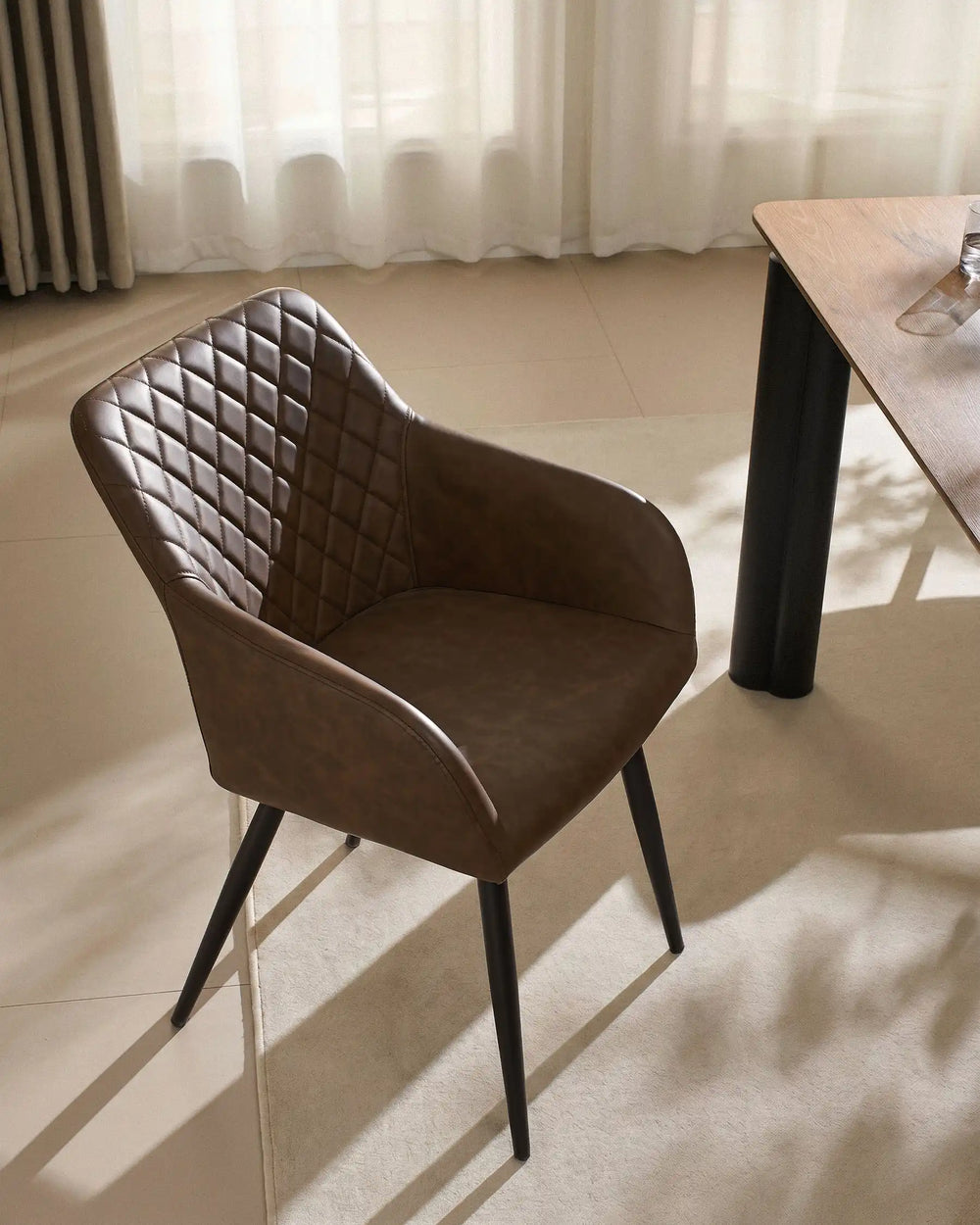 Single Moree Brown Faux Leather Dining Chair Beside Dining Table in Warm Modern Interior