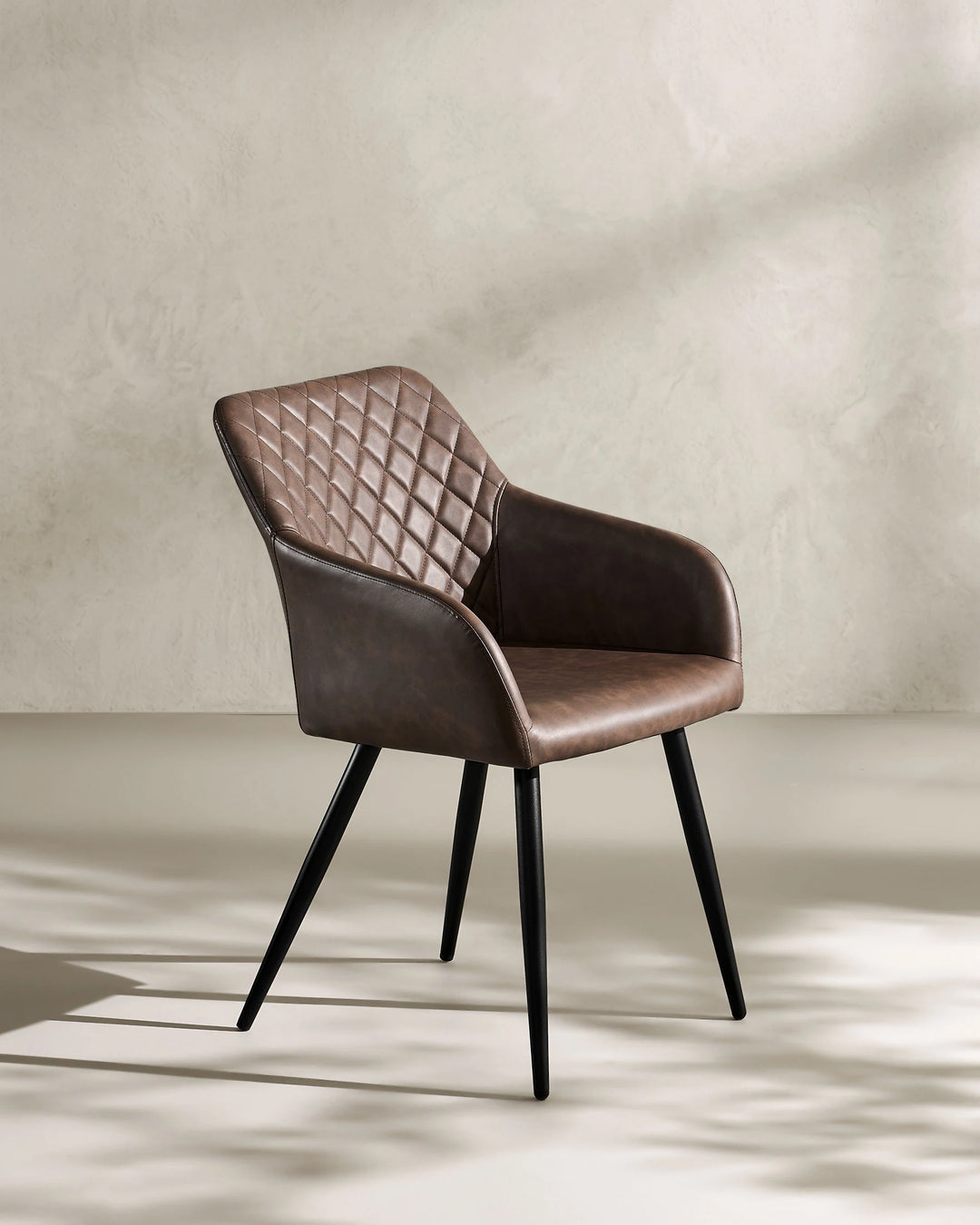 Moree Brown Faux Leather Dining Chair Side 45 Degree View on White Background with Natural Shadow