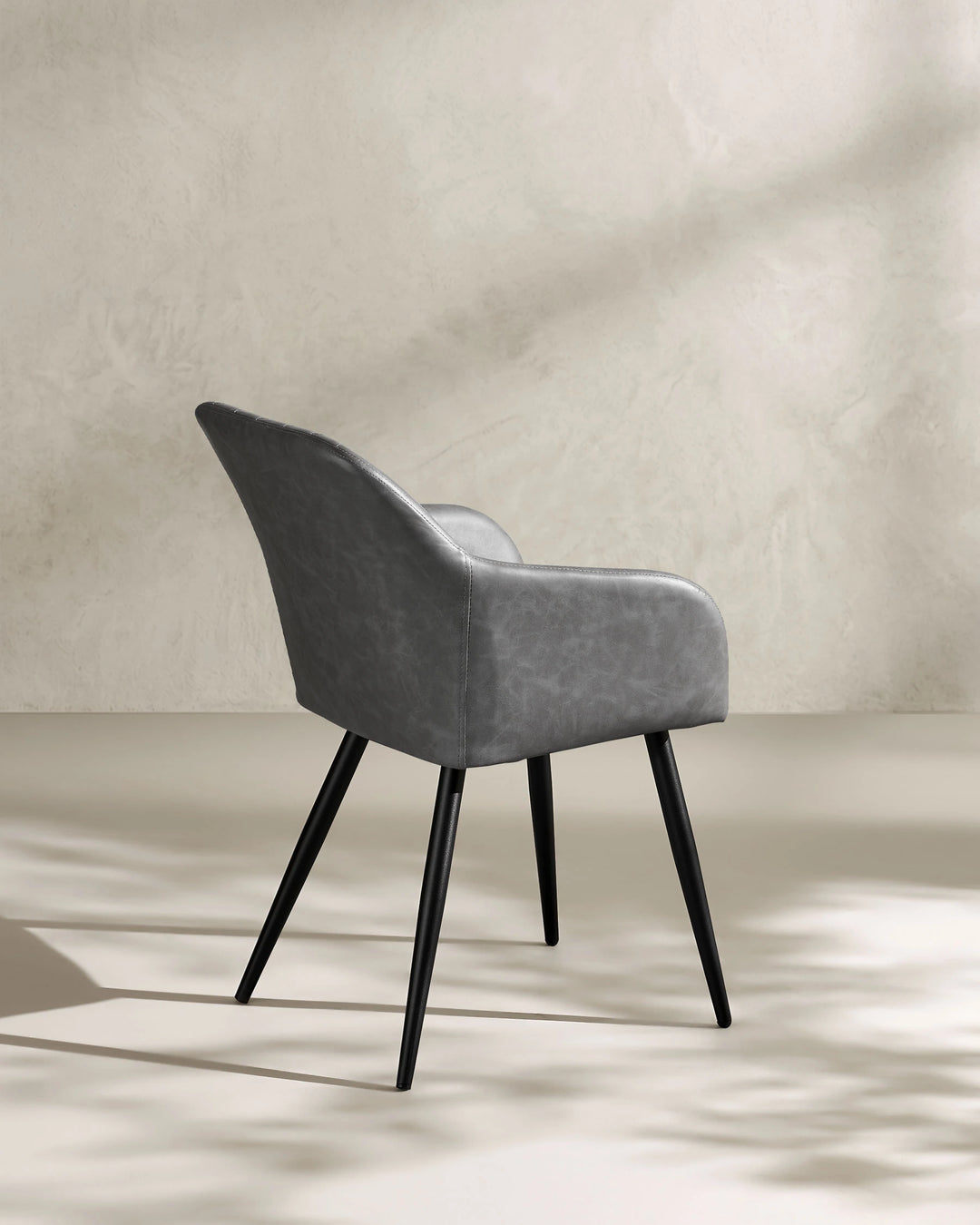 Moree light grey Faux Leather Dining Chair Side 135 Degree View on White Background with Natural Shadow