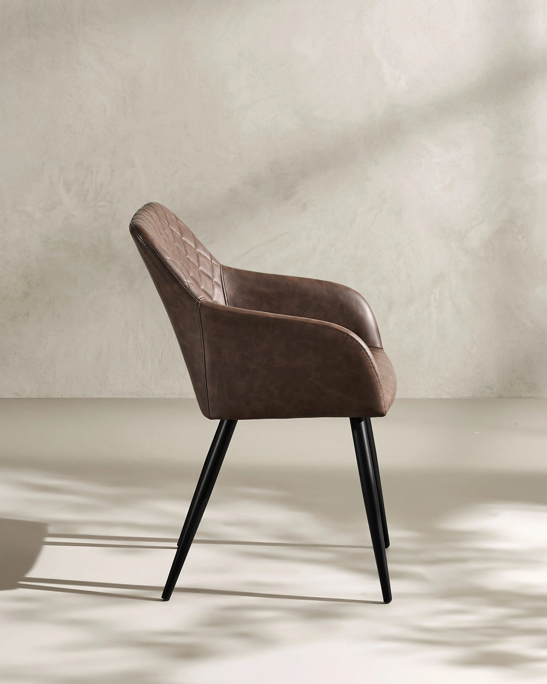 Moree Brown Faux Leather Dining Chair Side 90 Degree View on White Background with Natural Shadow