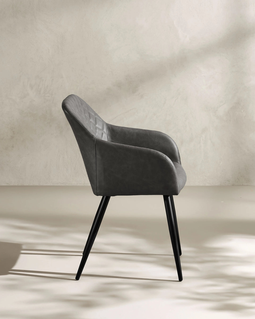 Moree dark grey Faux Leather Dining Chair Side 90 Degree View on White Background with Natural Shadow