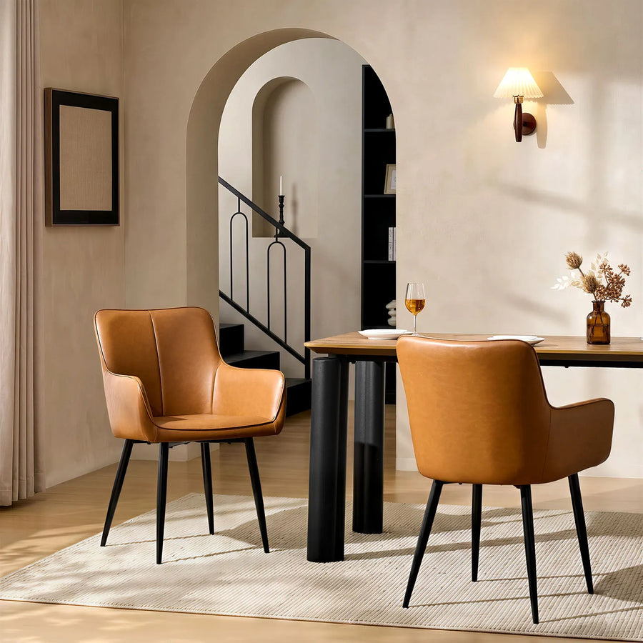 Two Muhsina brown faux leather dining chairs in a modern dining room setting