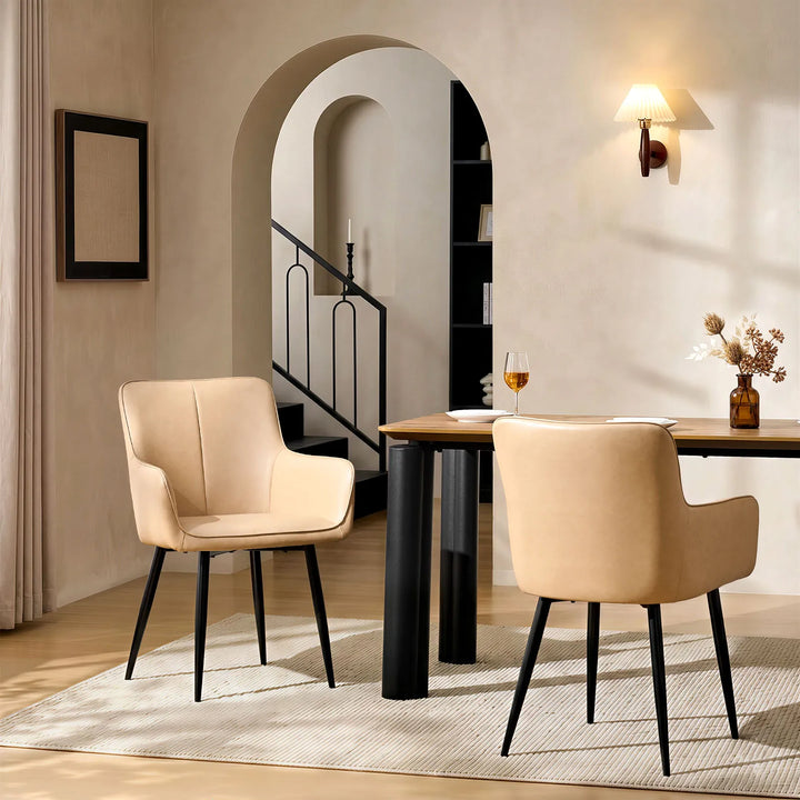 Two Muhsina beige faux leather dining chairs in a modern dining room setting