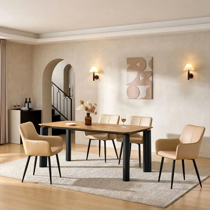 Side view of four Muhsina beige faux leather dining chairs in a dining room setting