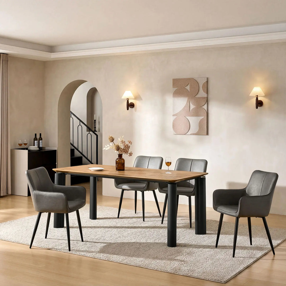 Side view of four Muhsina grey faux leather dining chairs in a dining room setting