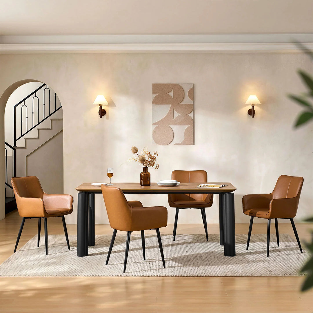 Four Muhsina brown faux leather dining chairs arranged around a dining table, front view