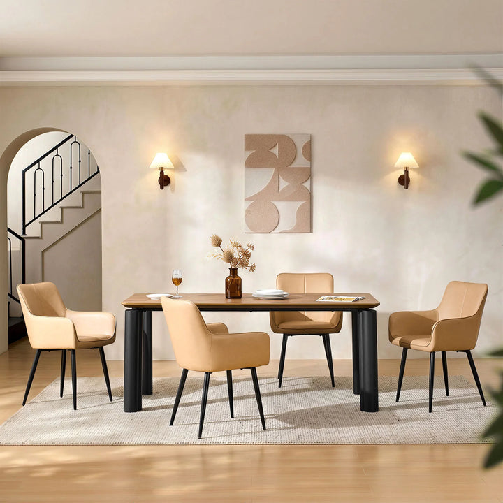 Four Muhsina beige faux leather dining chairs arranged around a dining table, front view