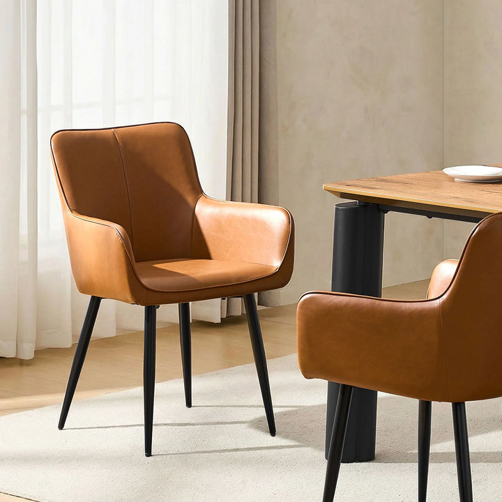 Single Muhsina brown faux leather dining chair styled in a contemporary dining space