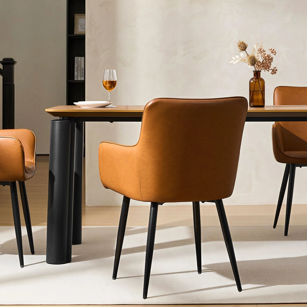 Single Muhsina brown faux leather dining chair styled in a contemporary dining space