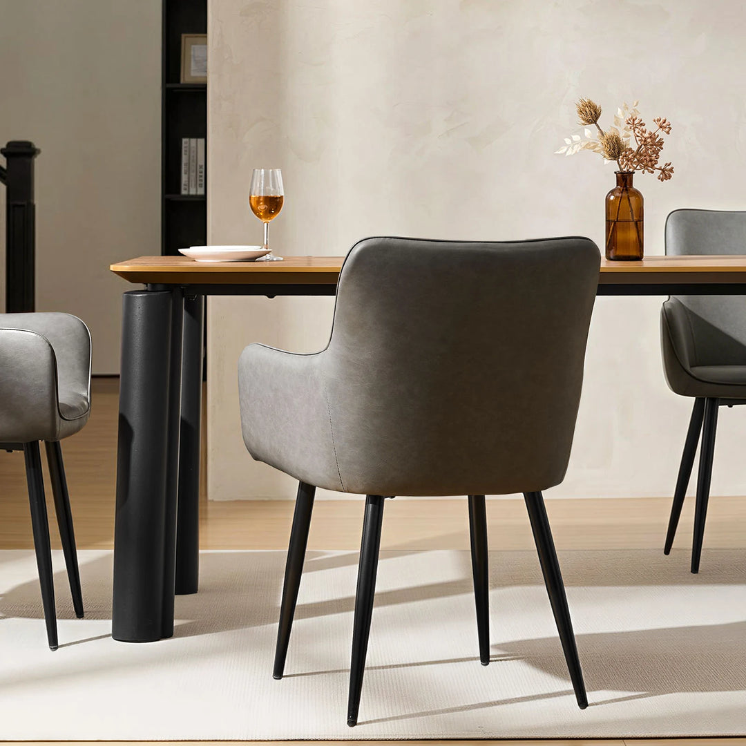 Single Muhsina grey faux leather dining chair styled in a contemporary dining space
