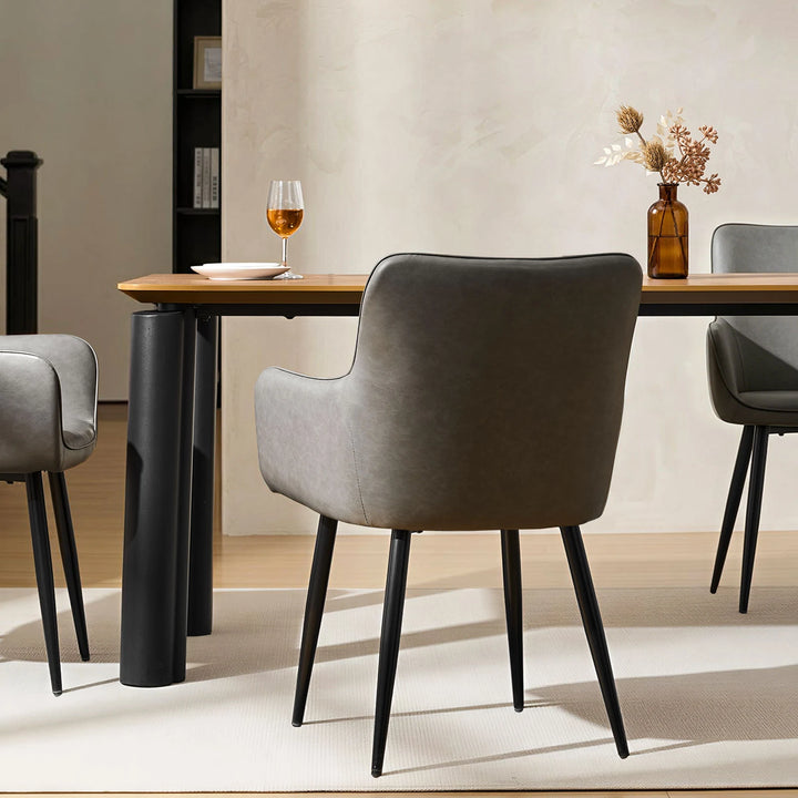 Single Muhsina grey faux leather dining chair styled in a contemporary dining space