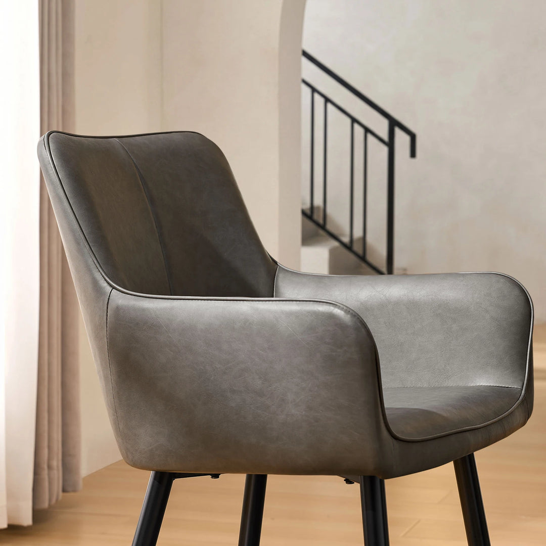 Side view armrest detail of Muhsina grey faux leather dining chair