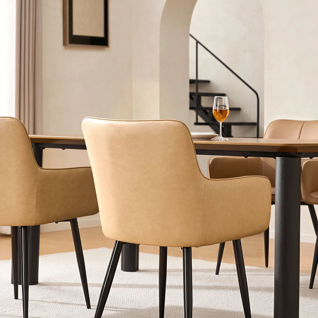 Single Muhsina beige faux leather dining chair styled in a contemporary dining space