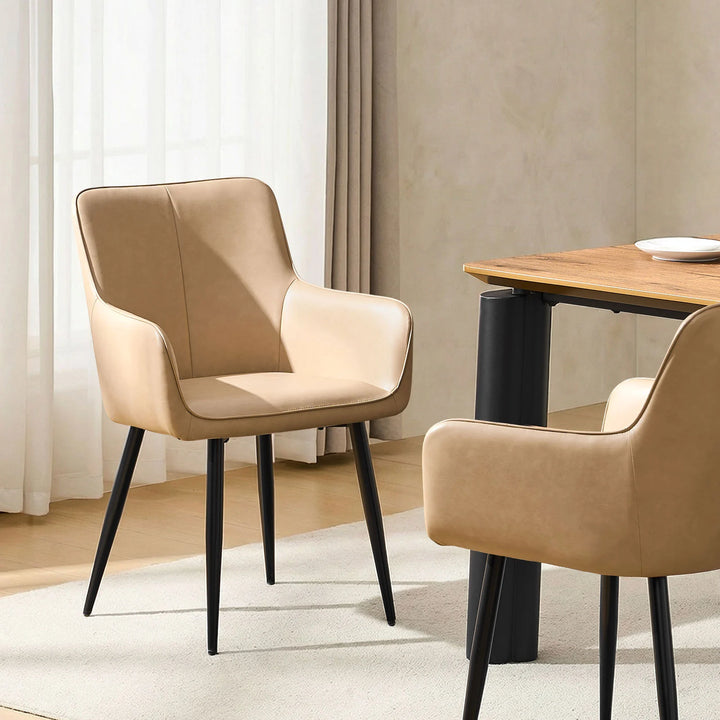 Single Muhsina beige faux leather dining chair styled in a contemporary dining space