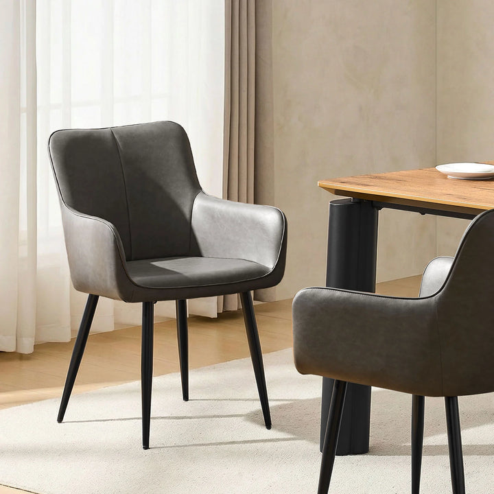 Muhsina grey faux leather dining chairs creating a sleek and modern dining room look