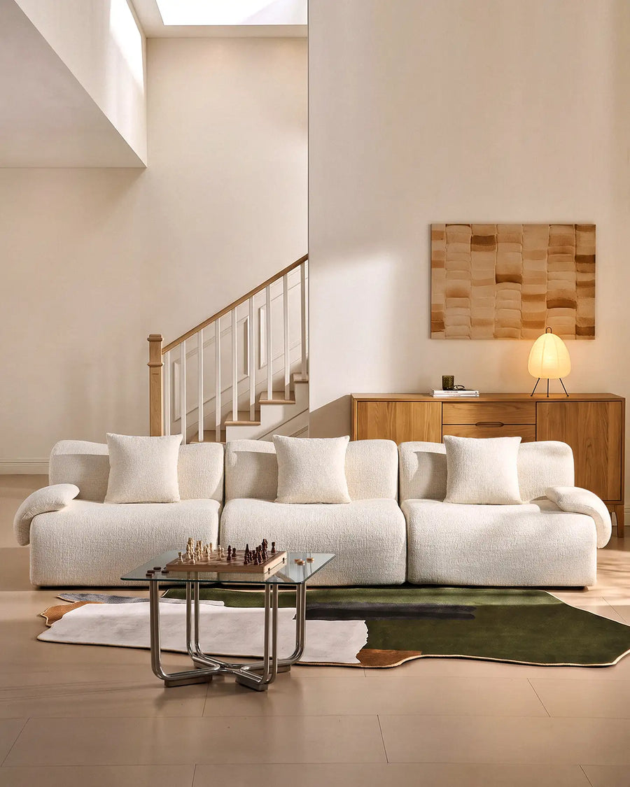 Nola 4-seater modular sofa in cream chenille fabric, styled in a minimalist modern living room.
