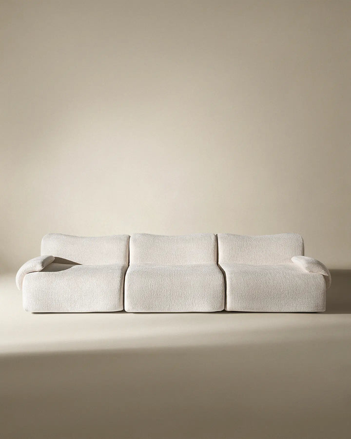 Front-on studio view of the Nola modular sofa, highlighting its minimalist and symmetrical aesthetic.