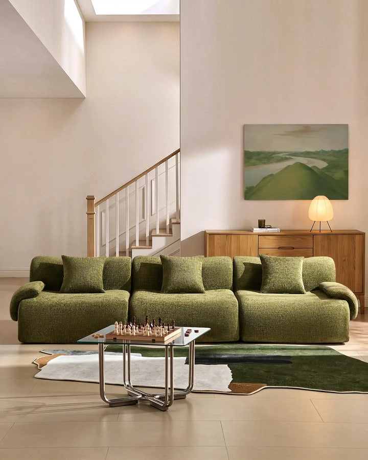Nola 4-seater modular sofa in green chenille fabric, styled in a minimalist modern living room.