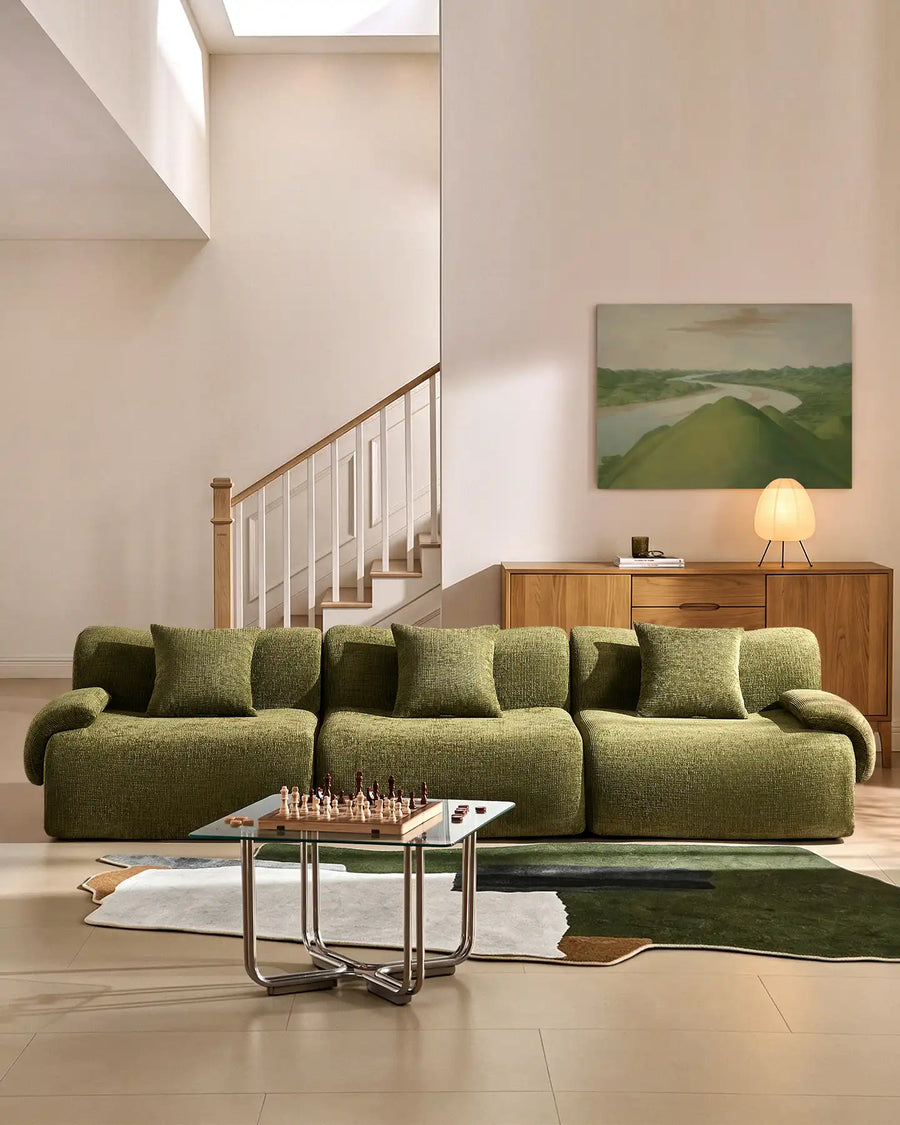 Nola 4-seater modular sofa in green chenille fabric, styled in a minimalist modern living room.