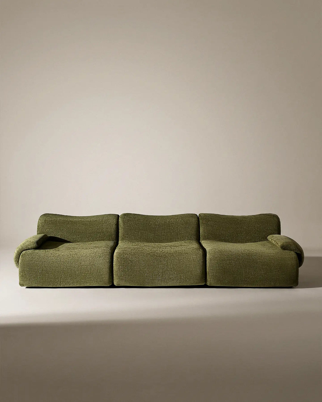 Front-on studio view of the Nola modular sofa, highlighting its minimalist and symmetrical aesthetic.