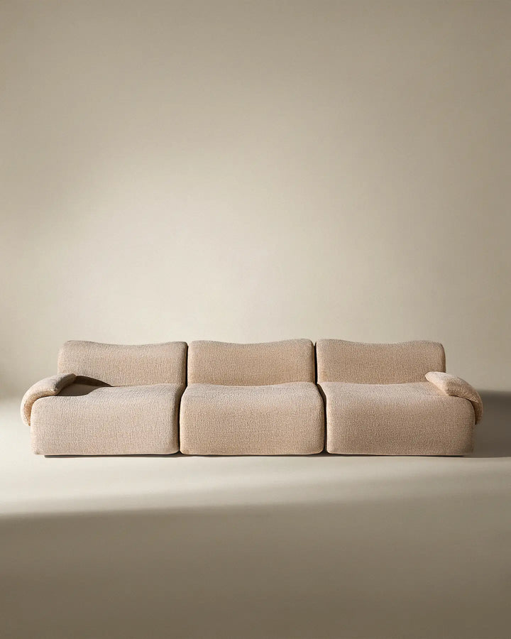 Front-on studio view of the Nola modular sofa, highlighting its minimalist and symmetrical aesthetic.