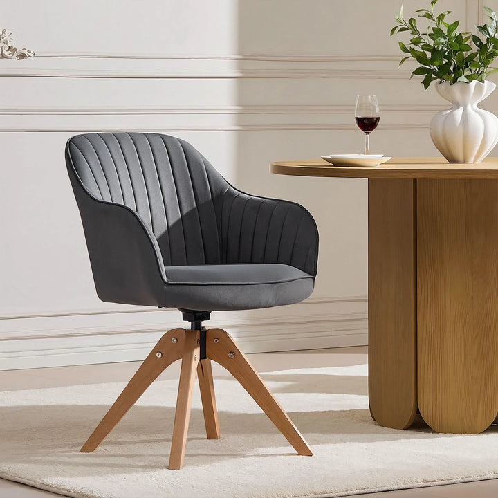 Single grey Oakley swivel chair at a dining table, featuring a bucket-style seat and stitched back for comfort and minimalist style