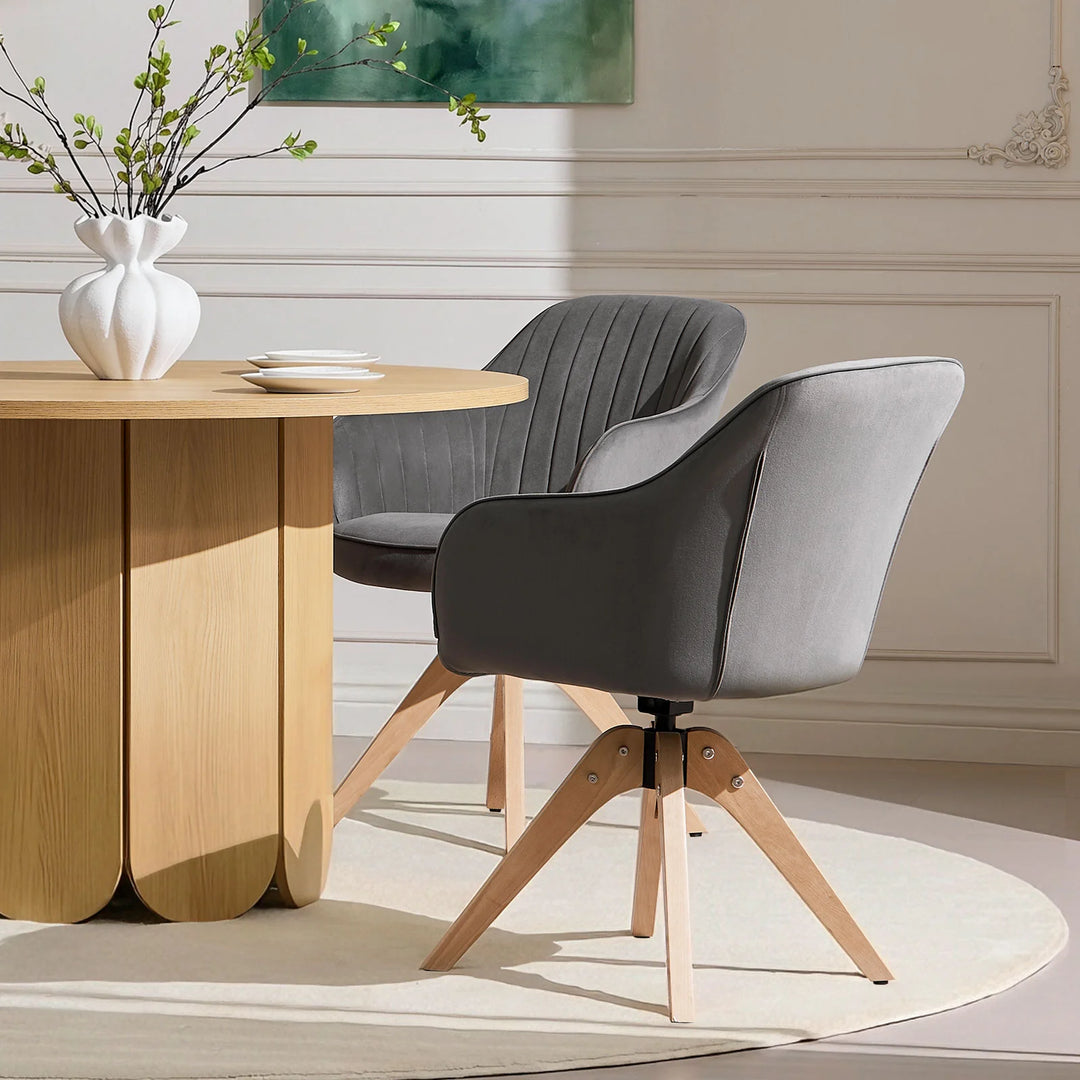 Pair of grey Oakley swivel dining chairs positioned at a dining table