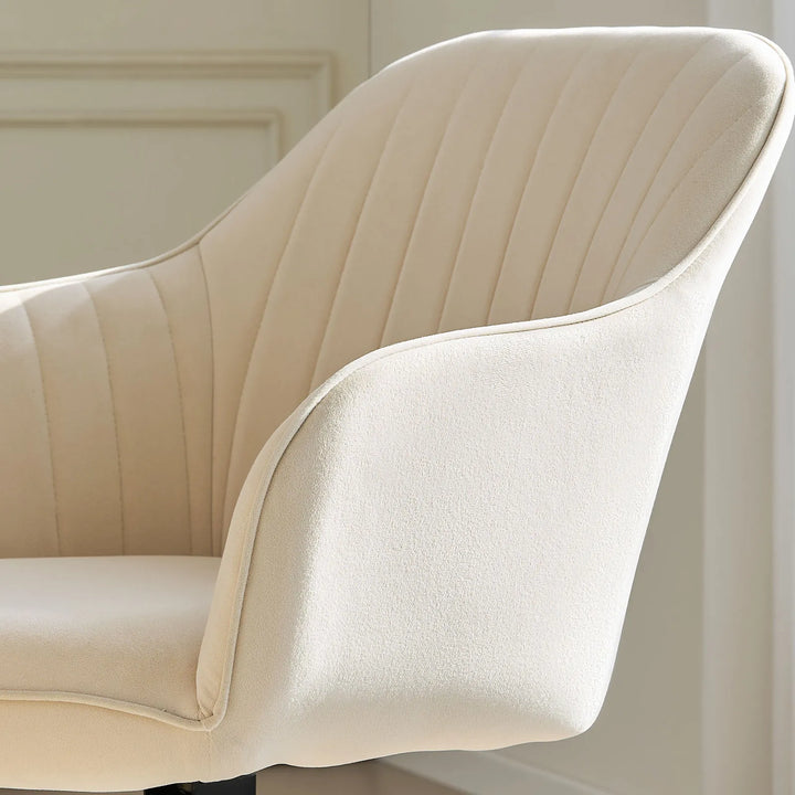 Armrest and seat detail of the beige Oakley velvet swivel chair, with soft velvet fabric for added comfort