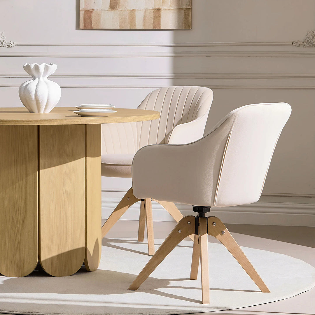Pair of beige Oakley swivel dining chairs positioned at a dining table
