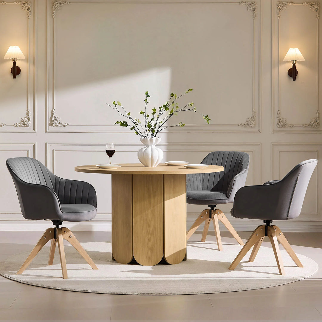 Three grey Oakley swivel chairs arranged around a dining table, offering comfortable everyday dining seating