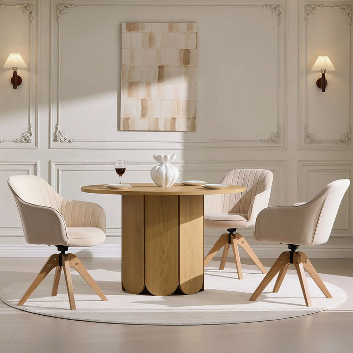 Three beige Oakley swivel chairs arranged around a dining table, offering comfortable everyday dining seating