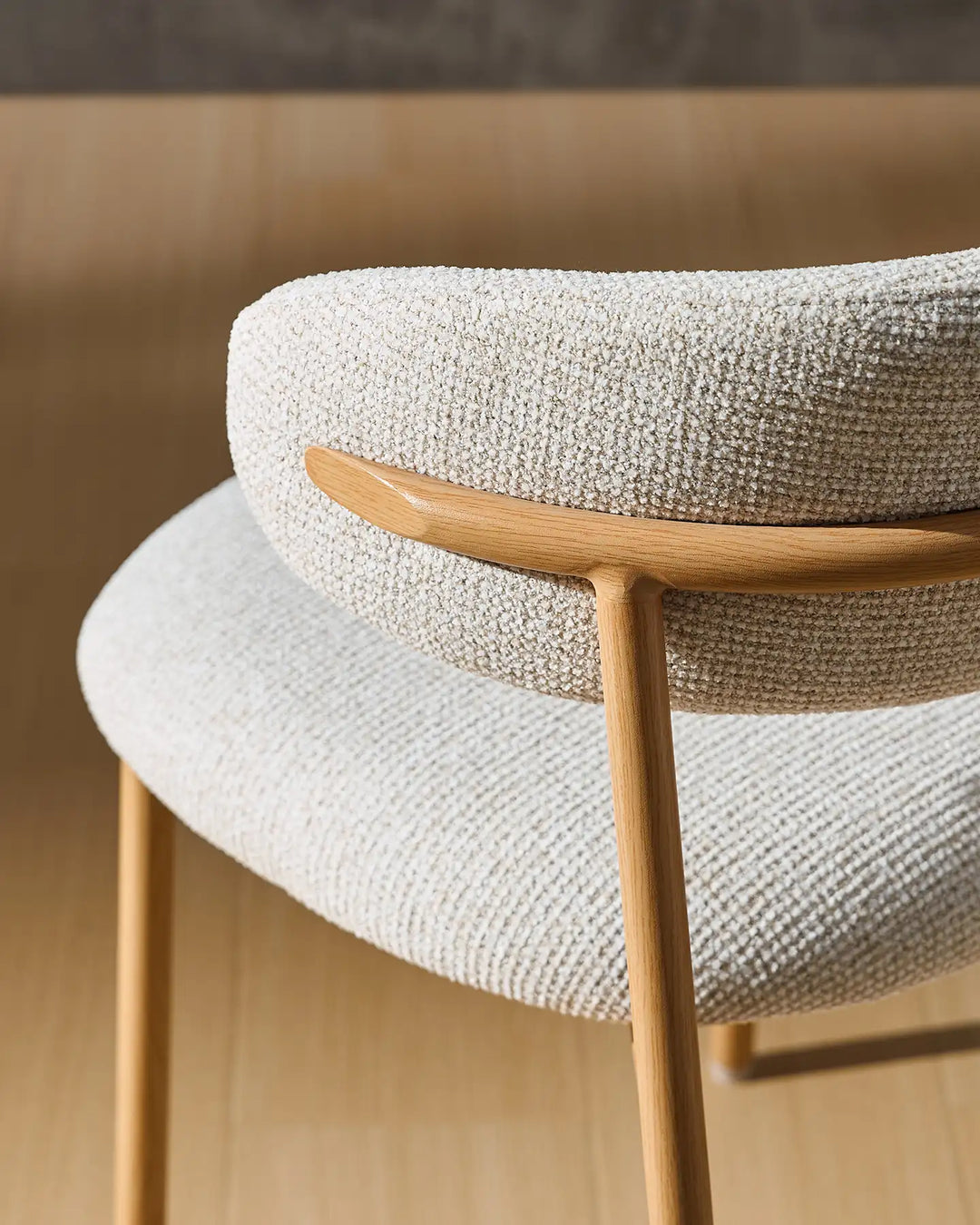 Detail of the Rowan oak-effect dining chair highlighting the seamless connection between the backrest and wood-effect legs