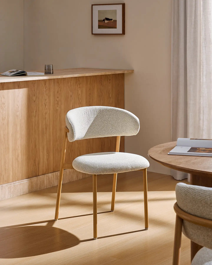 Rowan oak dining chair placed beside a dining table, bringing warmth and character to a modern farmhouse furniture setting