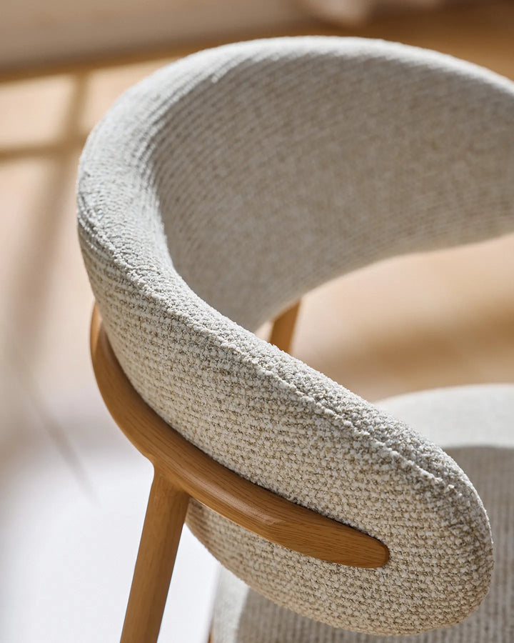 Close-up of the Rowan dining chair featuring an elegant curved backrest with soft, supportive shaping